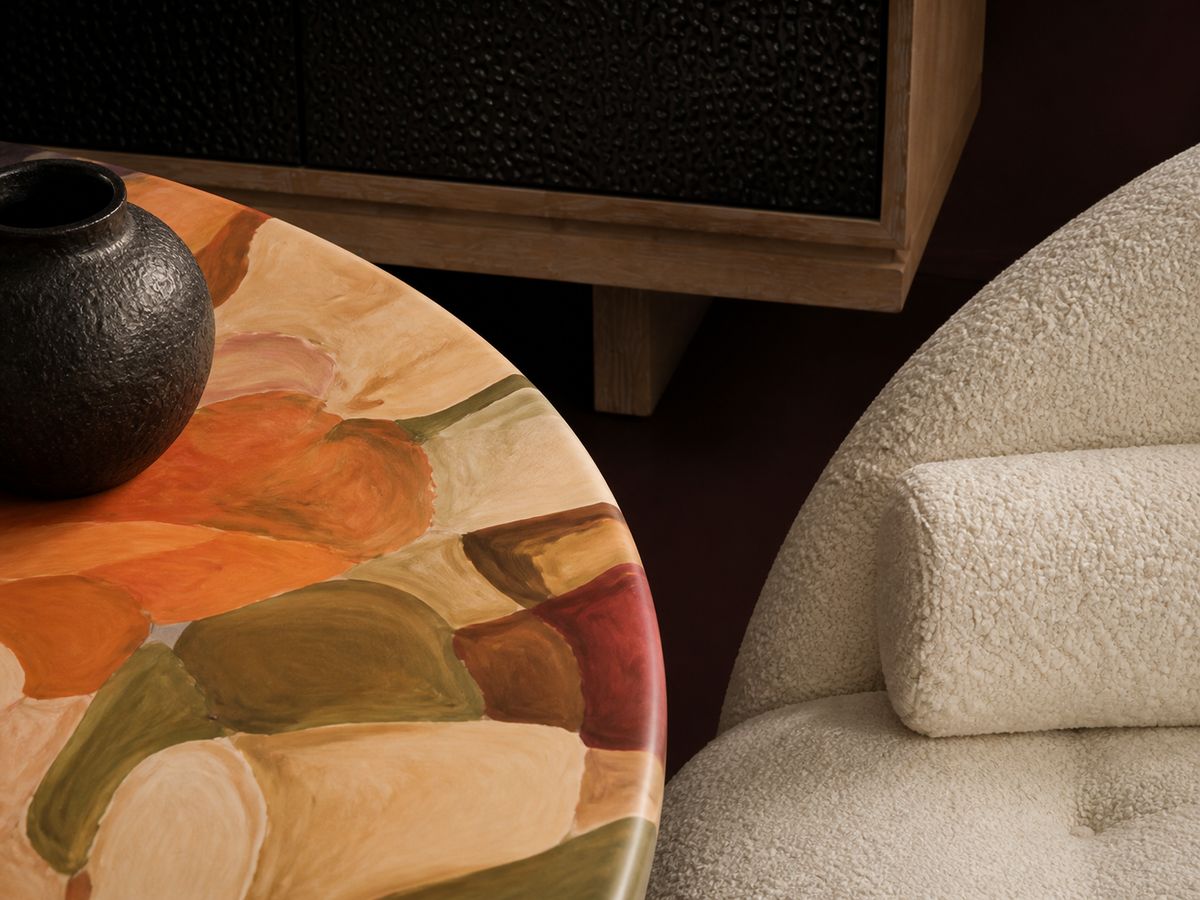 Close view of painted furniture surfaces, timber grain and tactile upholstery